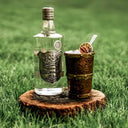Ștefan cel Mare Moment: Bottle of vodka on a wooden coaster with a cocktail in the grass