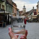 Ștefan cel Mare Moment: Vodka glass held in a hand on a street background