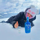 My Voronskaya Moment: Person in winter clothing lying in the snow with a blue bottle and glass, surrounded by snow and ice.