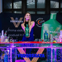 Vodka Voronskaya Bio - Barista holding a Voronskaya vodka bottle at a bar counter with brand logos in the background.
