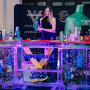 Vodka Voronskaya Bio - Voronskaya vodka display with a model holding a bottle at a promotional event.
