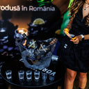 Vodka Voronskaya Black Edition - Vodka bottles in a block of ice on a table with a person in the background.