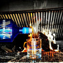 Vodka Voronskaya Blue - Voronskya vodka being poured into a glass with flames in the background