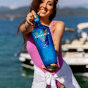Vodka Voronskaya Blue - Woman holding a blue bottle of Vodka Voronskaya by the water
