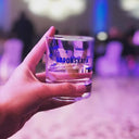 Vodka Voronskaya Classic - Hand holding a glass of VORONSKAYA vodka with a blurred background