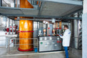 Voronskaya Vodka Factory - Person inspecting industrial equipment in a factory setting
