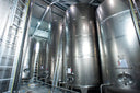 Voronskaya Vodka Factory - Large stainless steel tanks in a warehouse setting