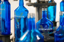 Voronskaya Vodka Factory - Blue bottles of Vodka Voronskaya on an assembly line.